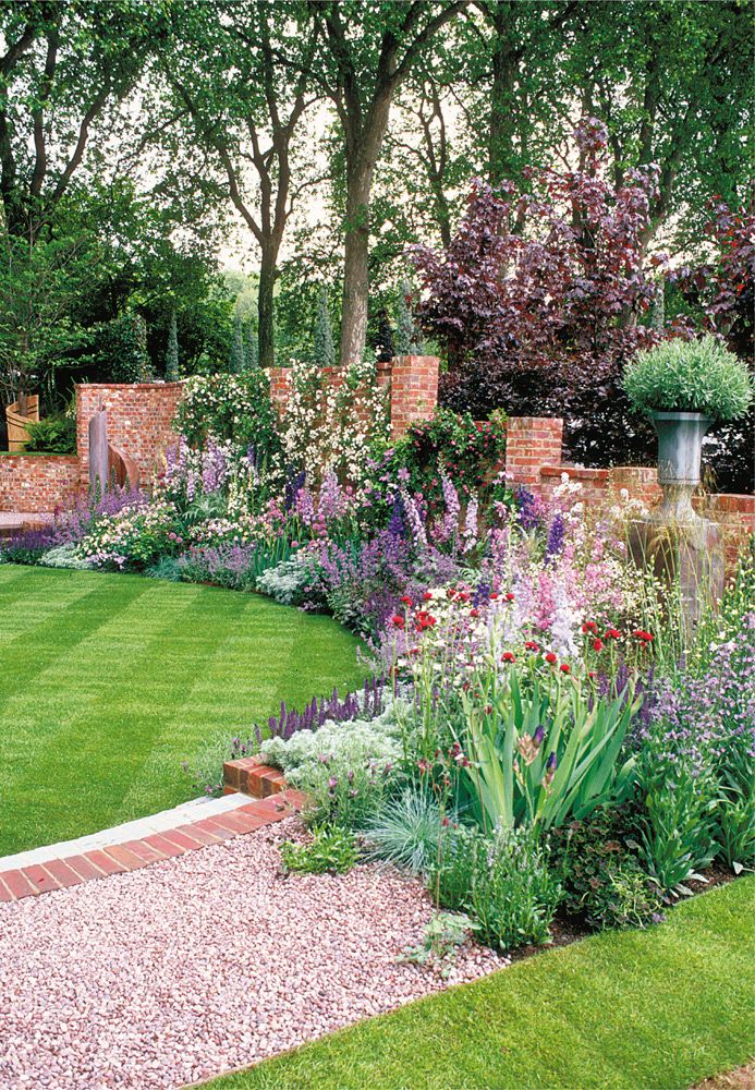 A neat green carpet lawn and a classic brick hardscape set the stage for this - photo 4