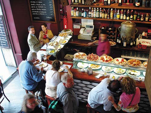 Barcelonans crowd into lively bars to feast on tapas small portions of olives - photo 11