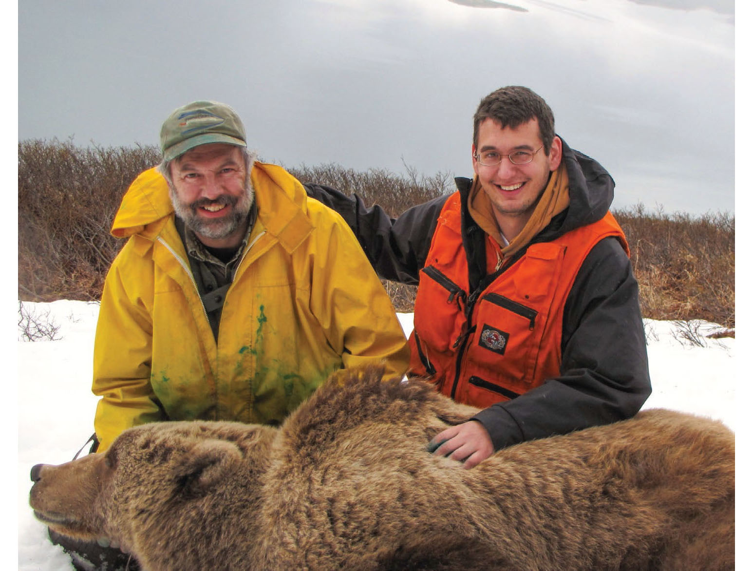 Larry and his son Matt with a tranquilized Kodiak bear above Karluk Lake - photo 12