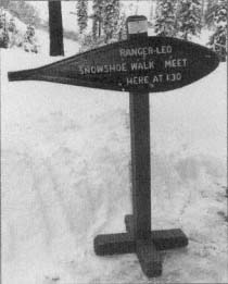 A sign welcomes visitors to join a snowshoe hike at Lassen Volcanic National - photo 3