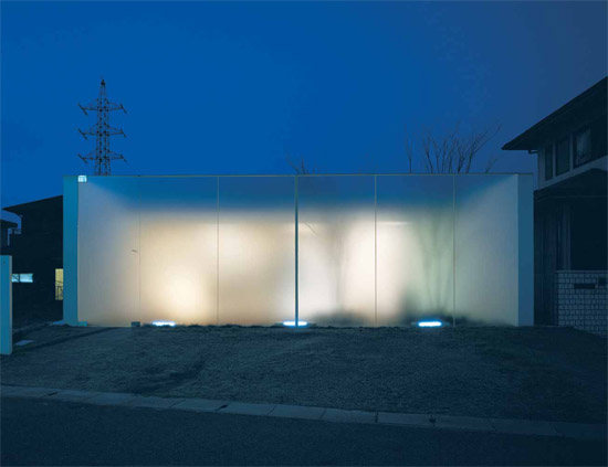 Abstract House glows at night from light issuing through the frosted glass wall - photo 1