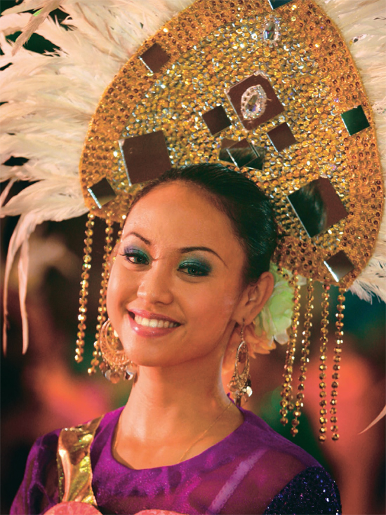 Dressed in traditional costume this young woman helps celebrate Malaysias - photo 4