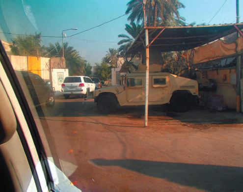 An Iraqi armoured vehicle guards a checkpoint at the crossing from the Green - photo 7