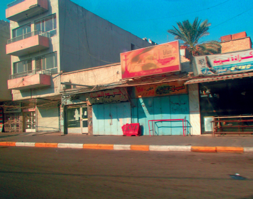 A typical street of shops and apartments in the Red Zone Baghdad A busy - photo 12