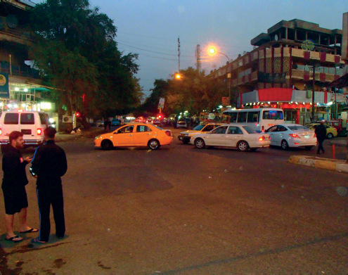 A busy intersection at night in the eastern part of Baghdad Just beyond the - photo 13