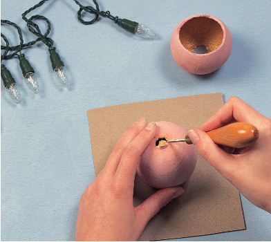 Place the gourd on a piece of card to protect the work surface and make a hole - photo 14