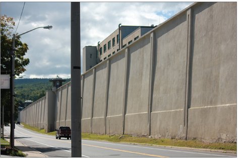 The Clinton Correctional Facility perimeter wall dominates the streetscape The - photo 5