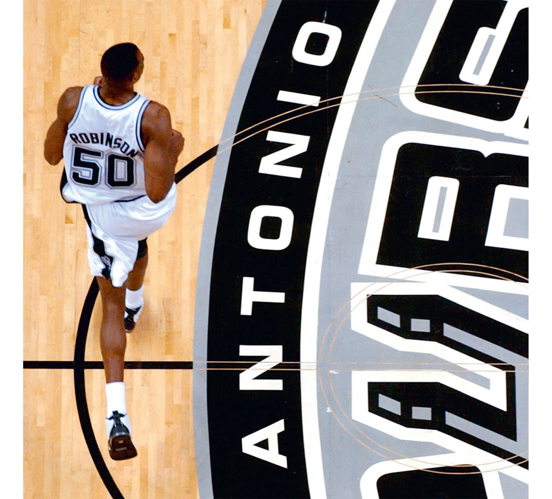 SPURS HIT JACKPOT David Robinson holds up his new jersey as he is welcomed - photo 7