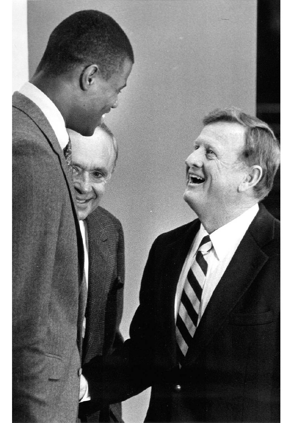 Red McCombs right shakes hands with David Robinson after the center announced - photo 9