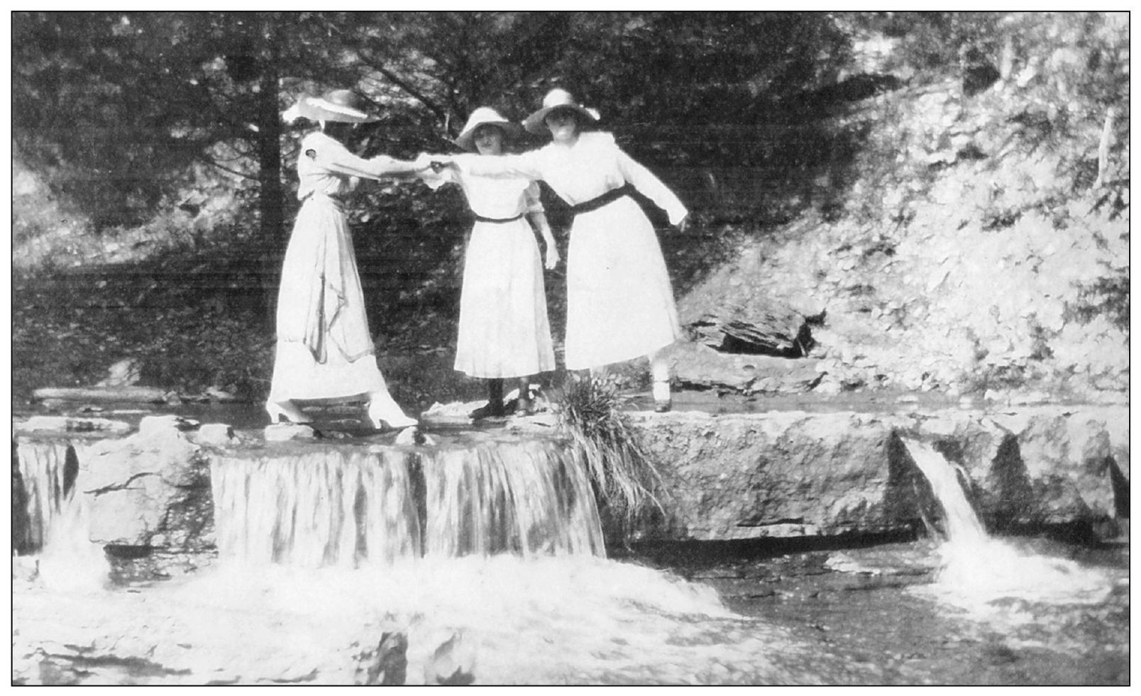 Shown in this photograph are three young ladies carefully navigating across a - photo 5