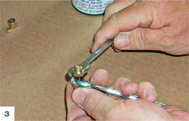 An open-end wrench is used to tighten the bushing down on the adapter An - photo 10