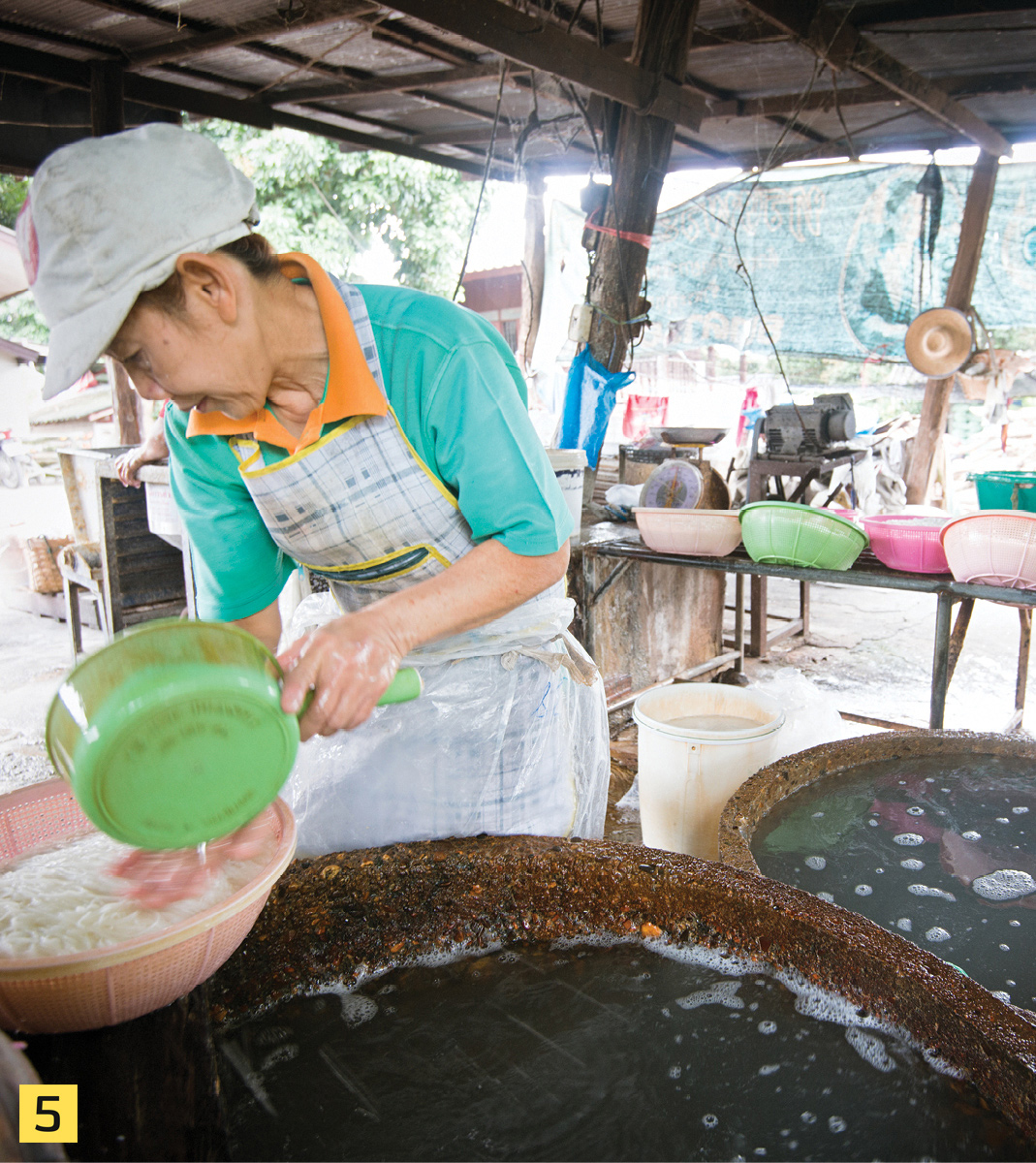 The cooked noodles are pulled from the boiling water with bamboo or plastic - photo 7