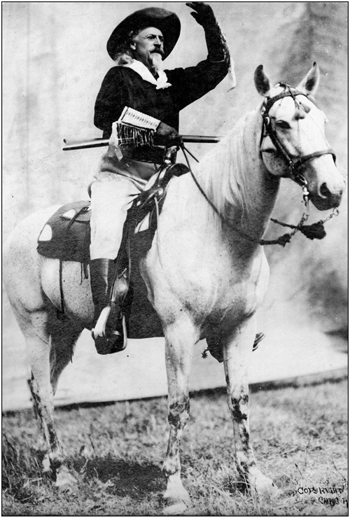 An iconic image of Buffalo Bill rifle in hand and riding a big white horse c - photo 4