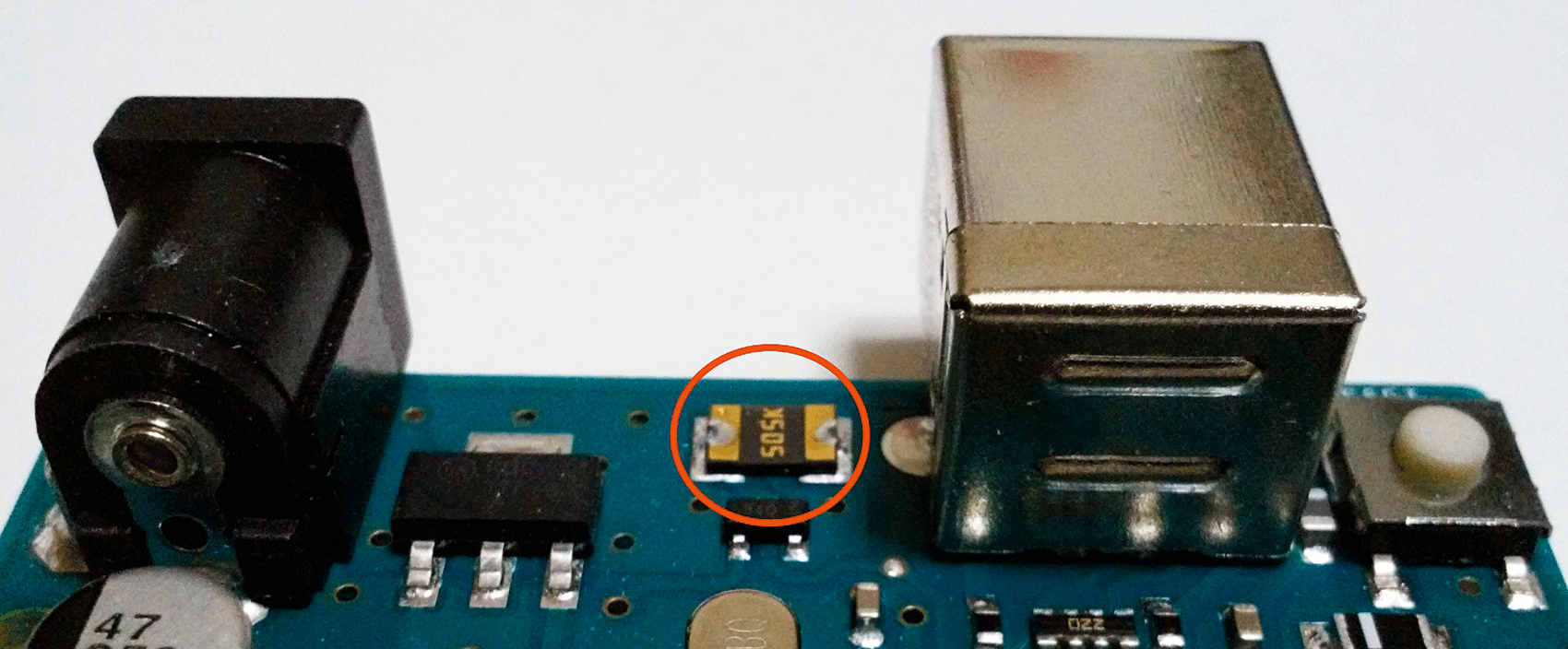 Figure 1-3 Metallic gold colored component on an official Arduino Uno board - photo 4