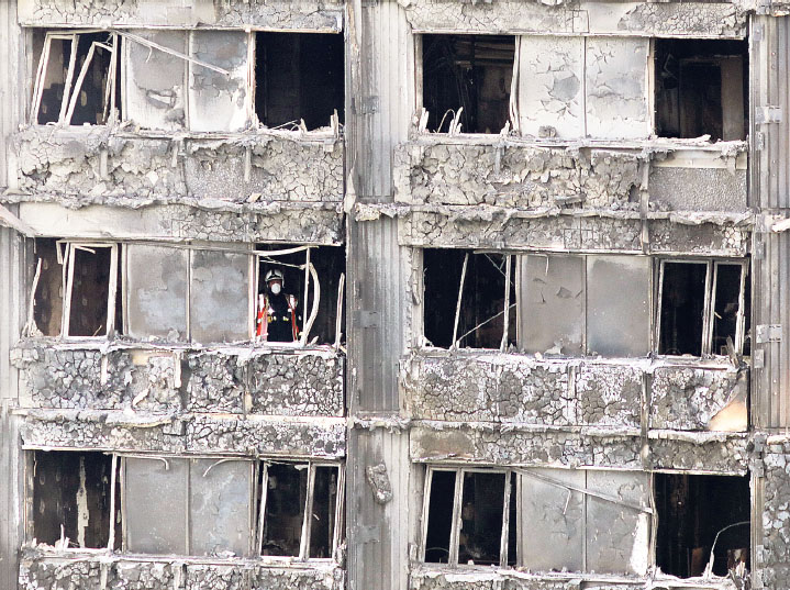 A firefighter photographed by Jack Hill keeps up the search for bodies in - photo 21