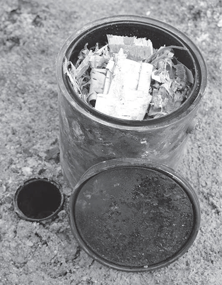 Birch bark packed into an old paint bucket with a small soup can buried to - photo 1