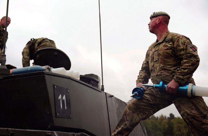 A Sergeant of the SCOTS DG hands APFSDS rounds up to his crewmen at the Joint - photo 3