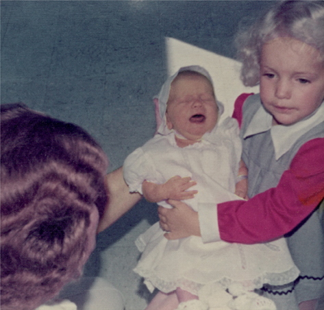 My sister Elise holding me for the first time in Mary Black Hospital in - photo 1