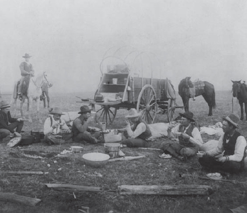 A group of cowboys taking a break at their chuck wagon These wagons carried - photo 4