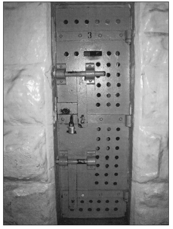 The cells were equipped with heavy iron doors solid except for a slit 10 by 3 - photo 11