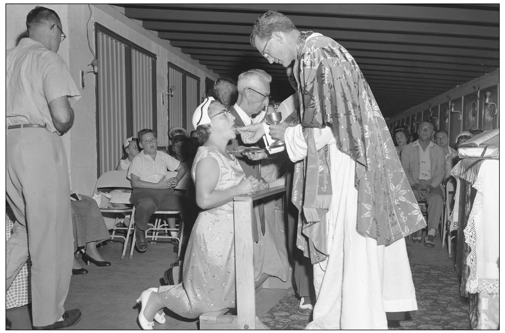 Parishioners at the newly founded St Clements Catholic Church receive mass - photo 10