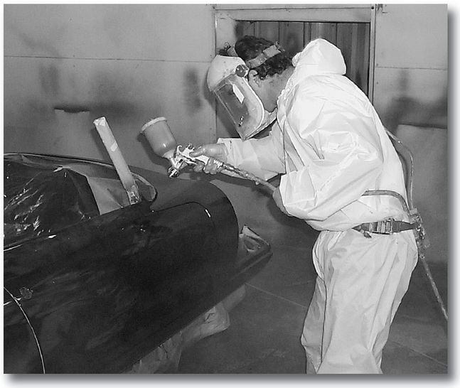 This painter wears a full plastic suit gloves and a positive pressure mask - photo 3