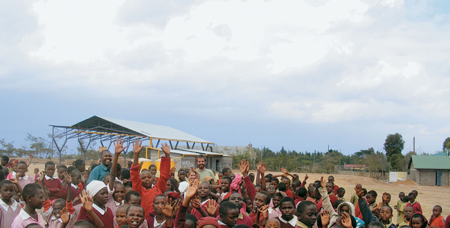 Architecture for Humanity Design Fellow Greg Elsner stands with community - photo 4