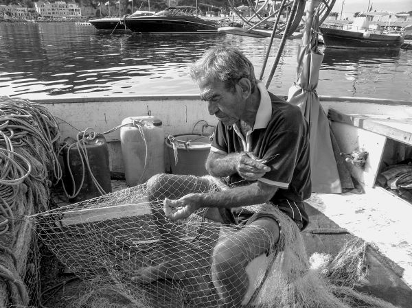 Figure 1 Fisherman Tonino Calise mending his nets in the harbor of Lacco Ameno - photo 3