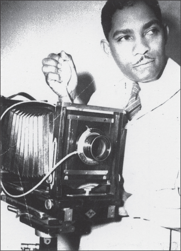 EF Joseph is pictured here with his camera and his workroom is seen below - photo 12