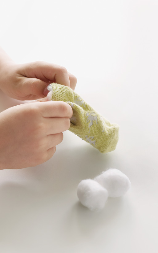 To make the penguins head stuff the baby sock with cotton balls and slip it - photo 10