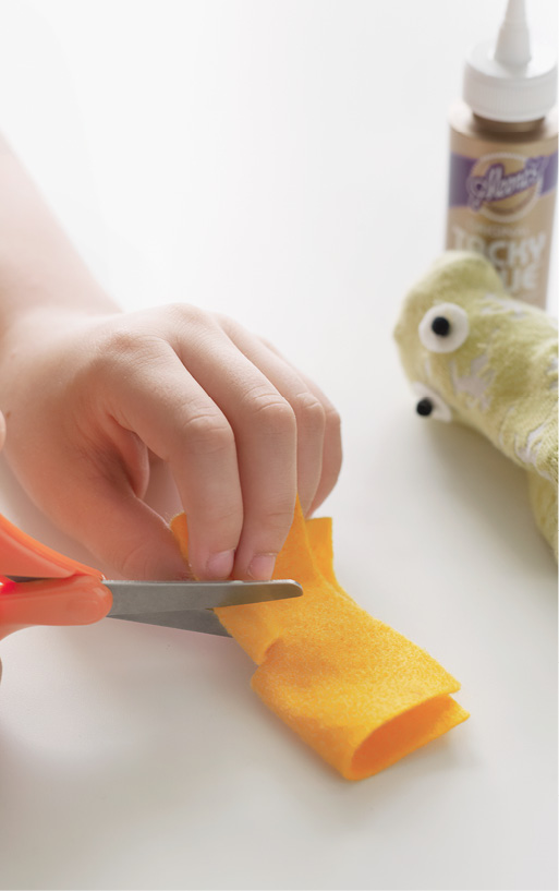 To make the beak fold a piece of yellow felt and cut a -inch triangle on the - photo 12