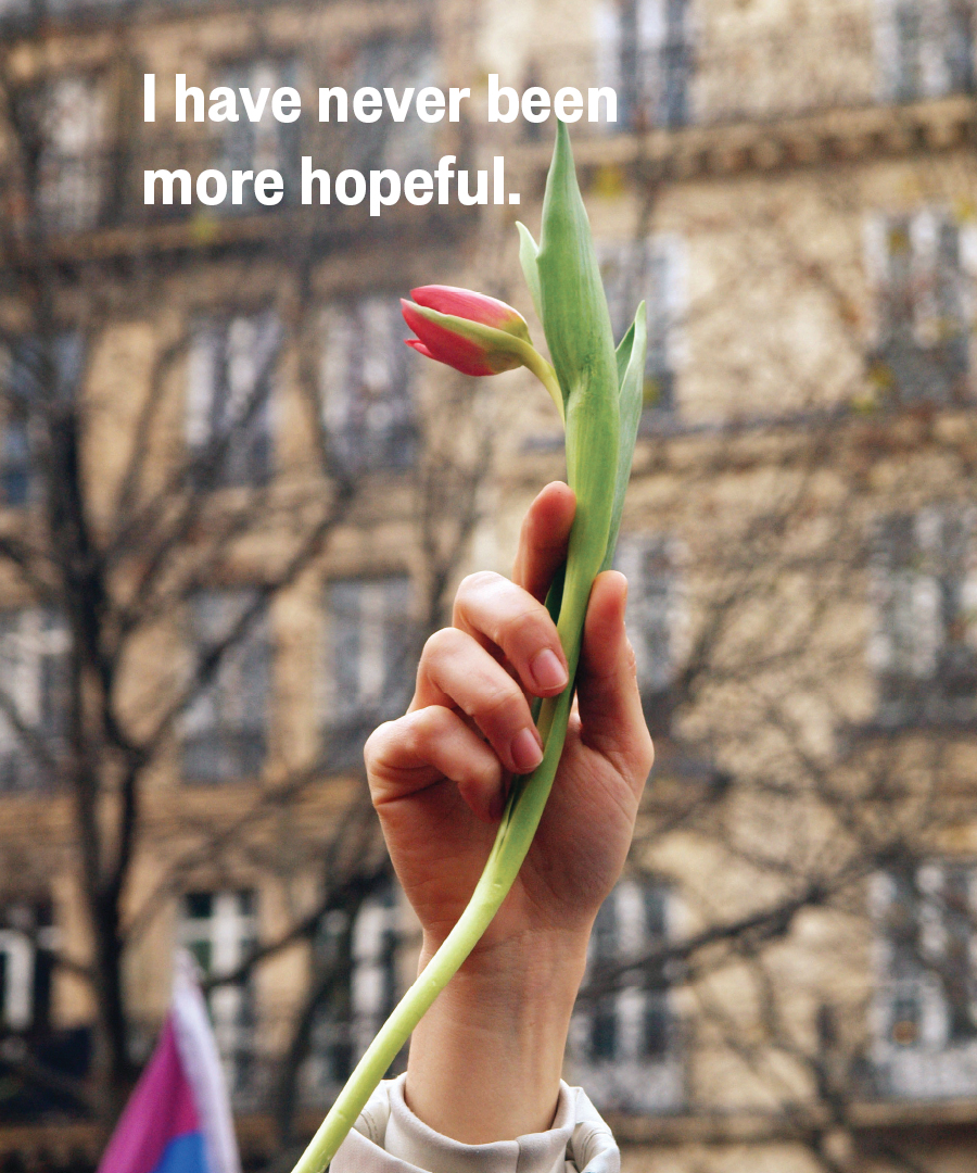 A young woman holds a symbolic tulip at a climate change demonstration - photo 8