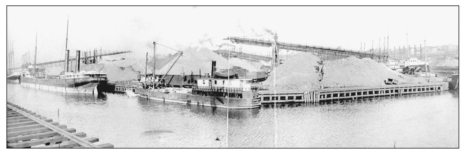 Piles of iron ore tower over early lake steamers in this image from the - photo 9