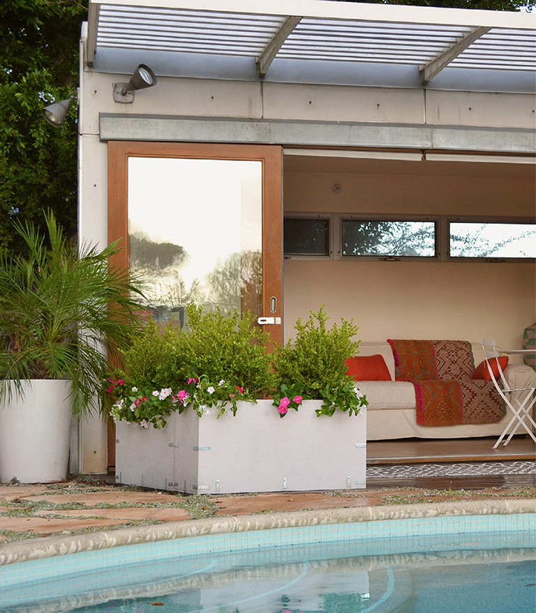 Common building materials are transformed into elegant planters by a poolside - photo 3