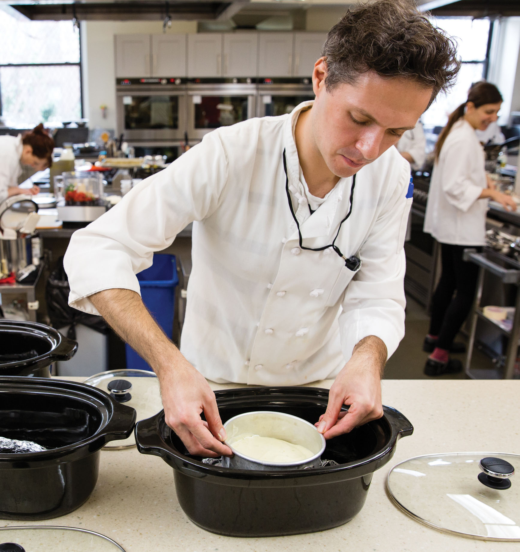 Test Cook Joe Gitter carefully lowers a 6-inch cake pan containing a Key lime - photo 3