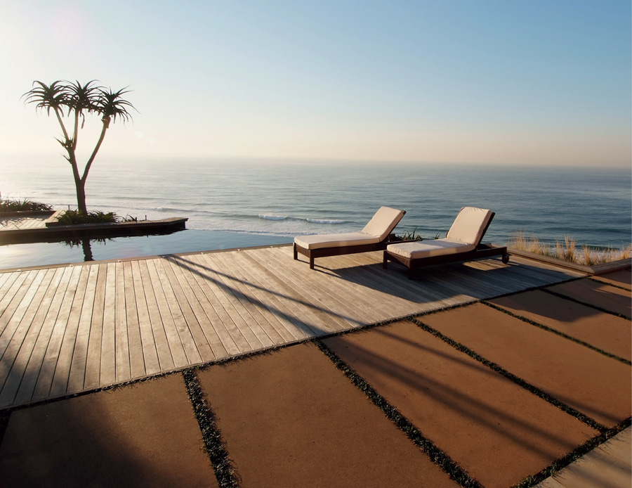 Custom-made sandblasted concrete pavers alongside the decking provide an - photo 4