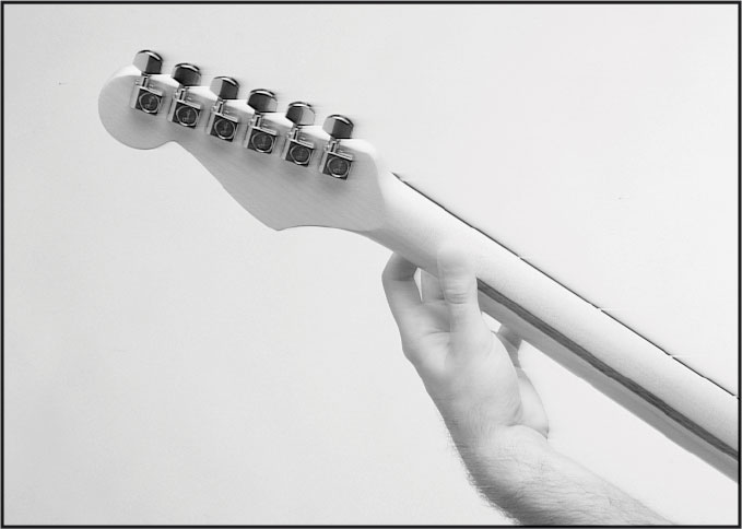 Place the first joint of your thumb on the back of the guitar neck Curl your - photo 8