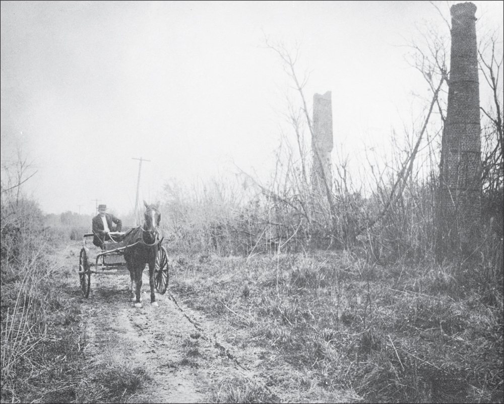 In 1912 a lone horse-drawn buggy makes it way down a dirt road At right are - photo 2