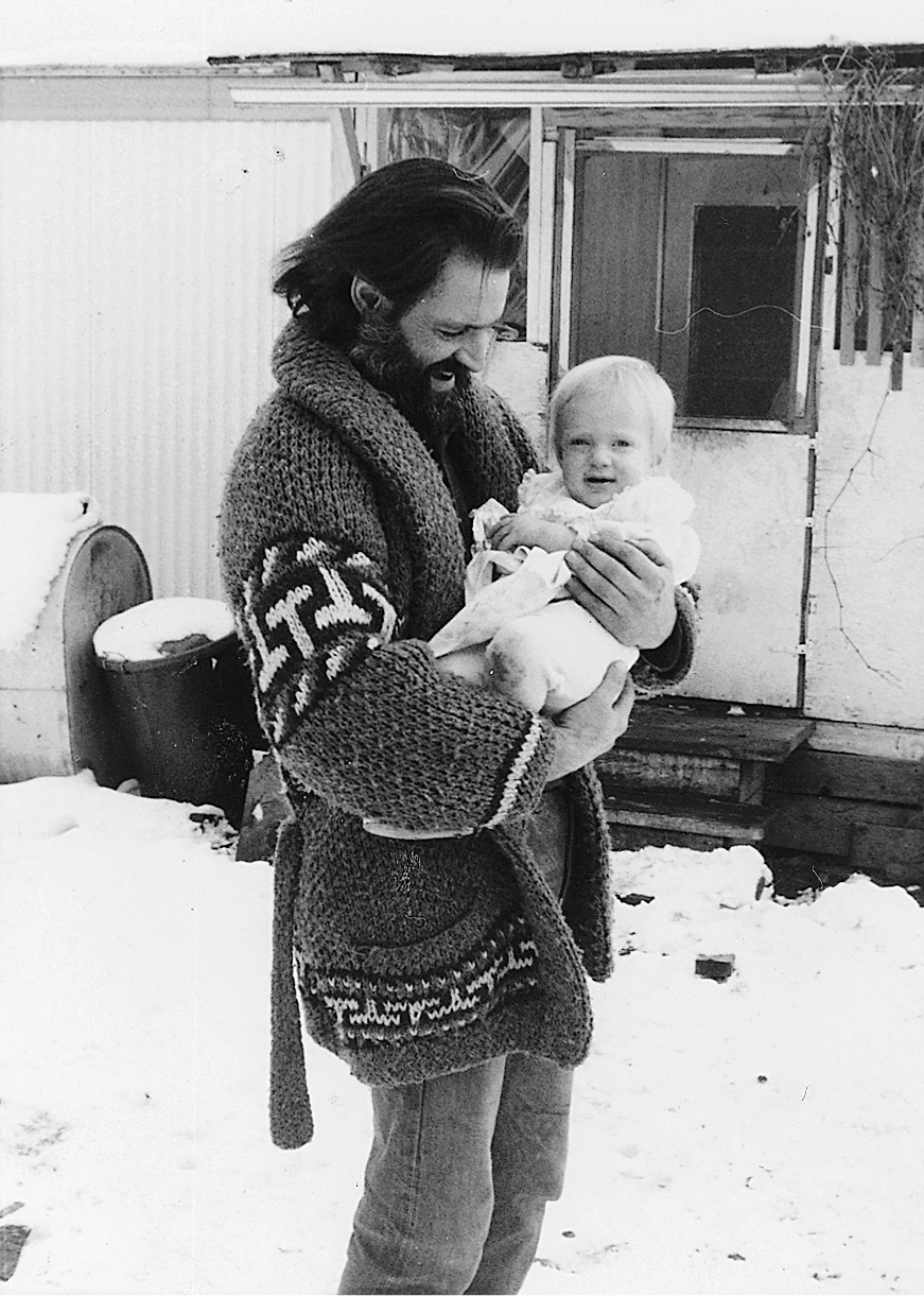 Dad holding one-year-old baby Novella on the ranch in Idaho The funky trailer - photo 5