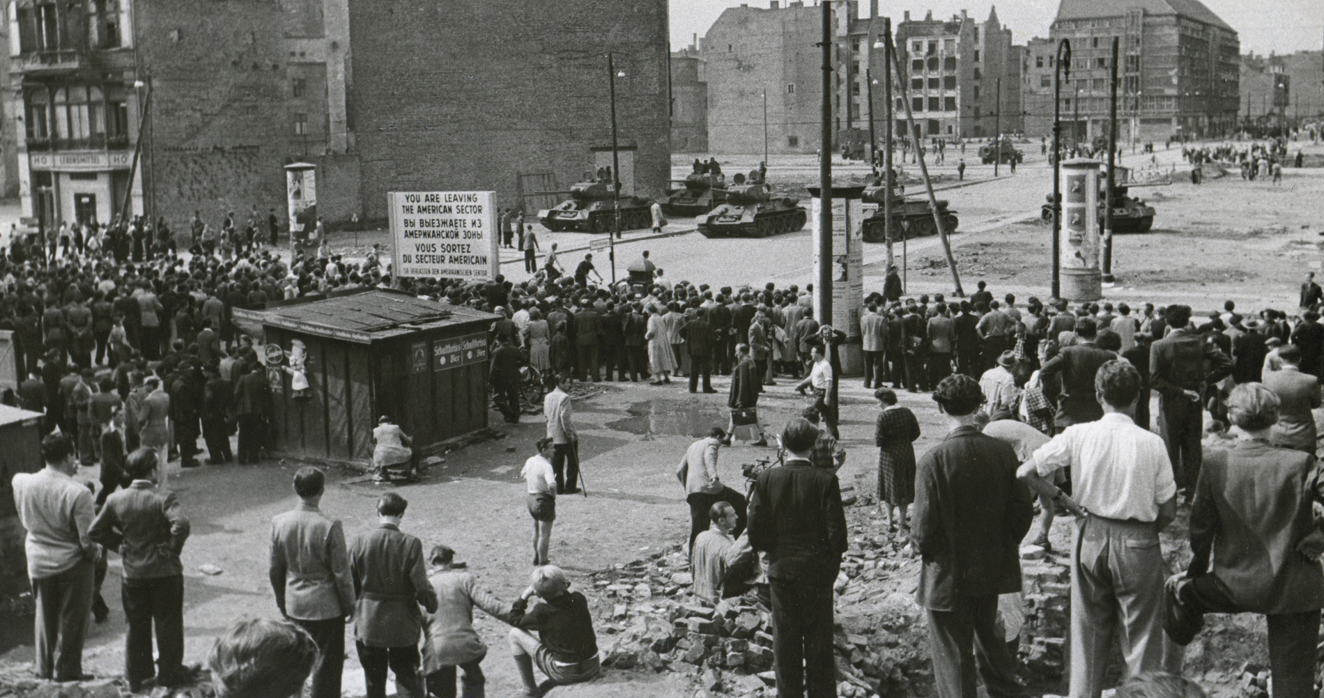 A crowd of onlookers in West Berlin watch Soviet Army tanks at Checkpoint - photo 4