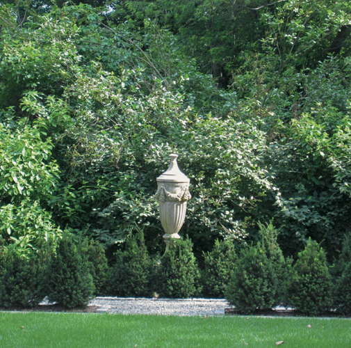 A large cast-stone urn creates a focal point in the green shrub borders ONE - photo 7