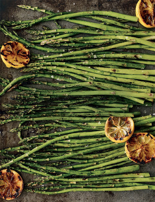 Market bins piled with bright green vegetablespeas fava beans asparagus - photo 7