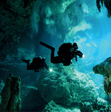 Divers use flashlights to explore a flooded cave system in Mexico Light - photo 7