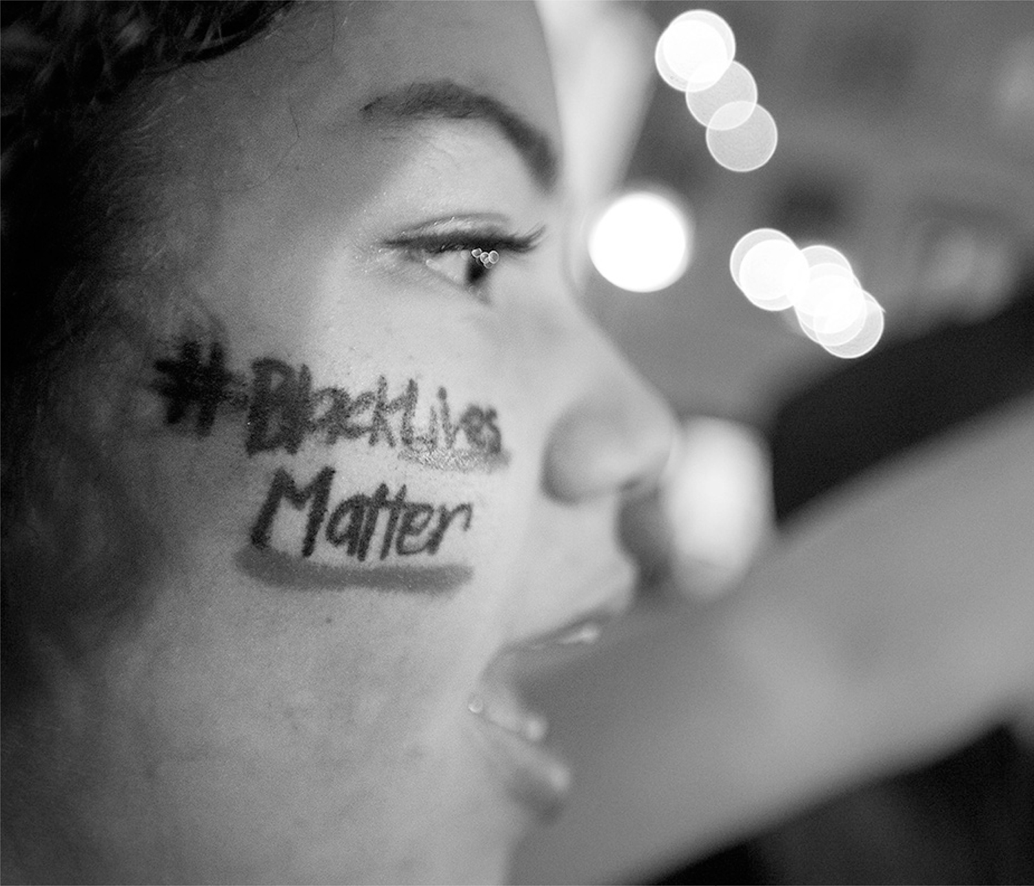 A protester sits in front of a street fire during a demonstration in Oakland - photo 2