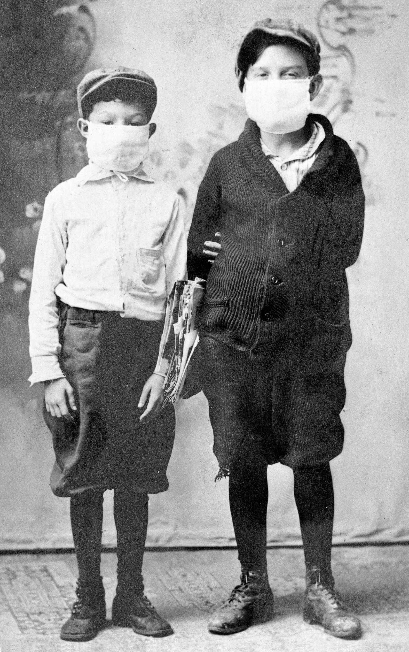 Two boys wearing masks the most visible symbol of the epidemic as it swept the - photo 8