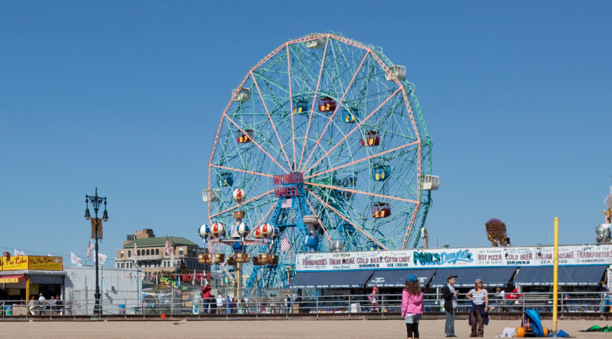 Giant Ferris wheel and restaurants along the sandy beach Coney Island - photo 8