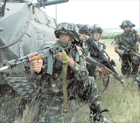 NATO troops stop for a communications break during a training exercise They - photo 3