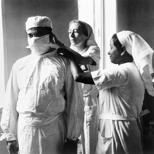 A nurse adjusts a doctors mask at a hospital in Calcutta Shortages of trained - photo 15