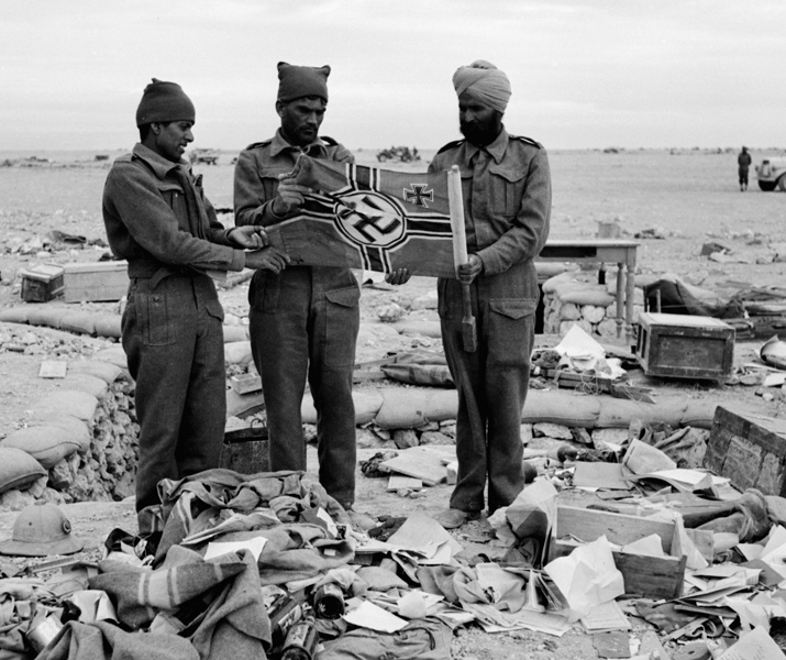 Men of the 4 th Indian Division with a captured German flag at Sidi Omar close - photo 7