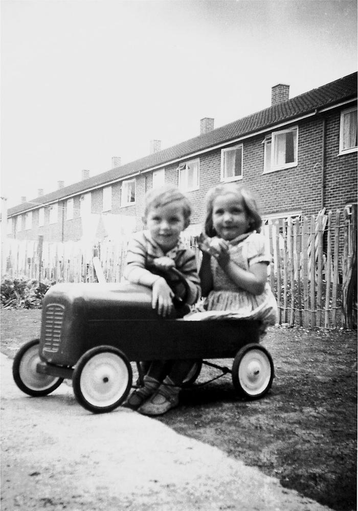 A young boy and girl enjoy a ride in their new red metal motorcar in South - photo 2